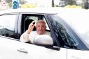 Pope Francis waves from a car as he leaves Rome's Gemelli hospital in Rome