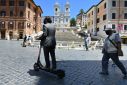 A rider passes the Spanish Steps in Rome, where a project is underway to clamp down on e-scooter use in the city