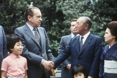 Former Japanese prime minister Kakuei Tanaka, who was arrested in 1976 in a kickback scandal, shakes hands with former president Richard Nixon, who resigned over the Watergate scandal, in 1982 in Tokyo