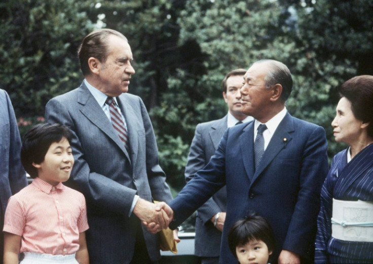 Former Japanese prime minister Kakuei Tanaka, who was arrested in 1976 in a kickback scandal, shakes hands with former president Richard Nixon, who resigned over the Watergate scandal, in 1982 in Tokyo