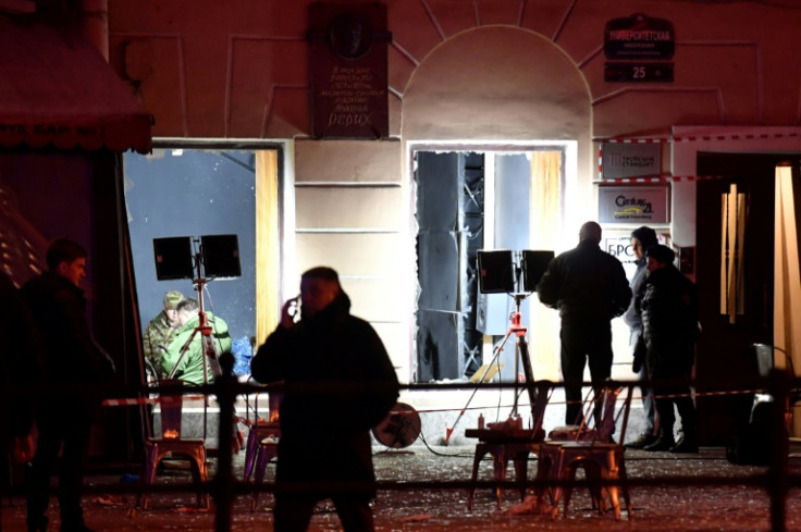 Russian police investigators inspect the damaged cafe in Saint Petersburg following the deadly blast