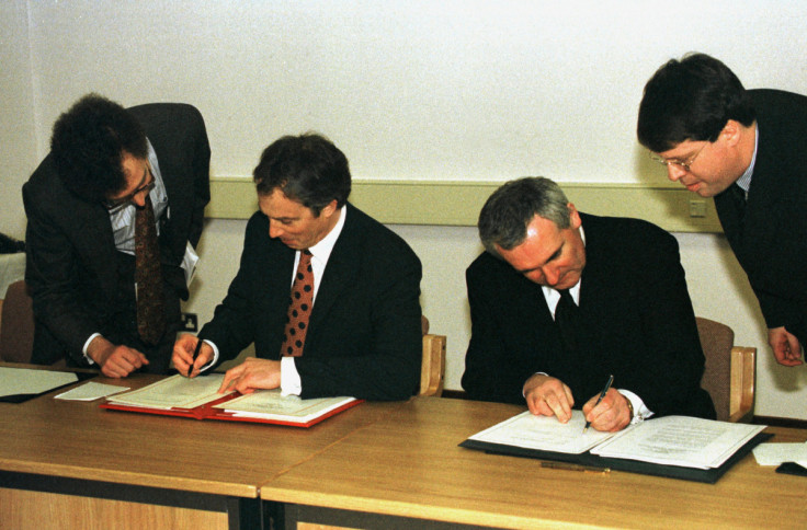 British Prime Minister Tony Blair (L) and Irish Prime Minister Bertie Ahern sign the peace agreement..