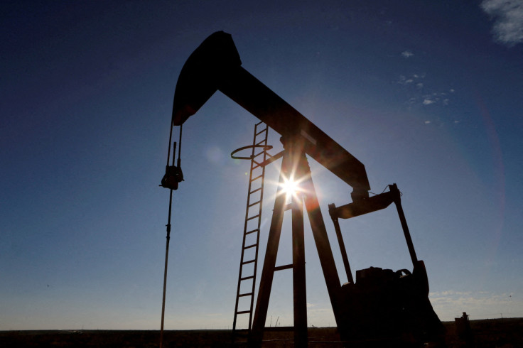 The sun is seen behind a crude oil pump jack in the Permian Basin in Loving County, Texas