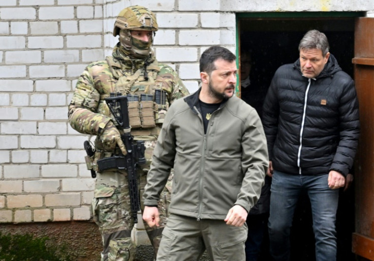 Ukrainian President Volodymyr Zelensky and German Vice Chancellor Robert Habeck (r) emerge from the basement of the school in Yagidne where villagers were kept for almost month by Russian troops