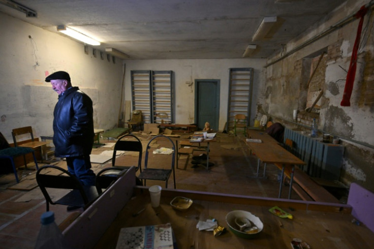 Ivan Polgui stands in the basement of the school where he and fellow villagers were held