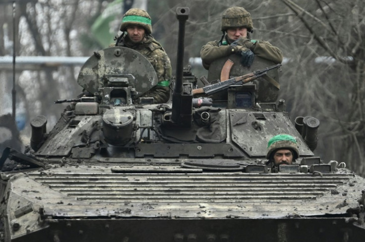 Ukrainian servicemen ride on an infantry fighting vehicle near the battleground city of Bakhmut on April 3, 2023