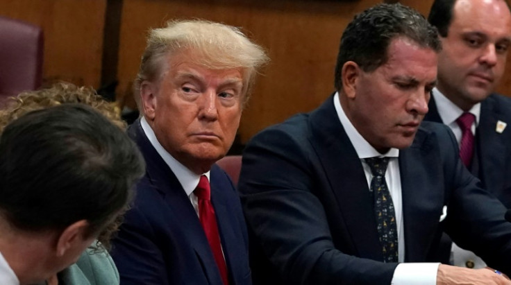 Former US president Donald Trump sits grim-faced at his arraignment Tuesday in New York over charges stemming from hush money payments