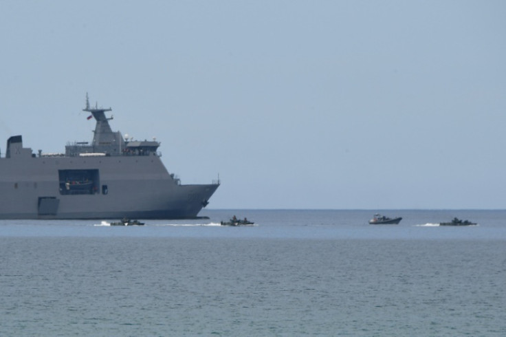 Philippine amphibious assault vehicles maneouver next to a navy ship during a joint exercise with US Marines at a beach facing the South China Sea in October 2022