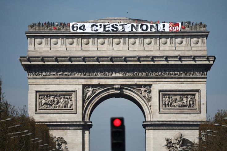 Activists unfurled a banner atop the capital's iconic Arc de Triomphe, reading