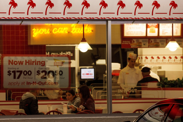 "Now hiring" sign displayed at a fast food restaurant in California