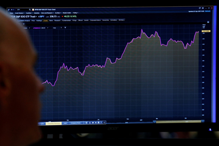 A trader looks at a screen that charts the S&P 500 on the floor in New York