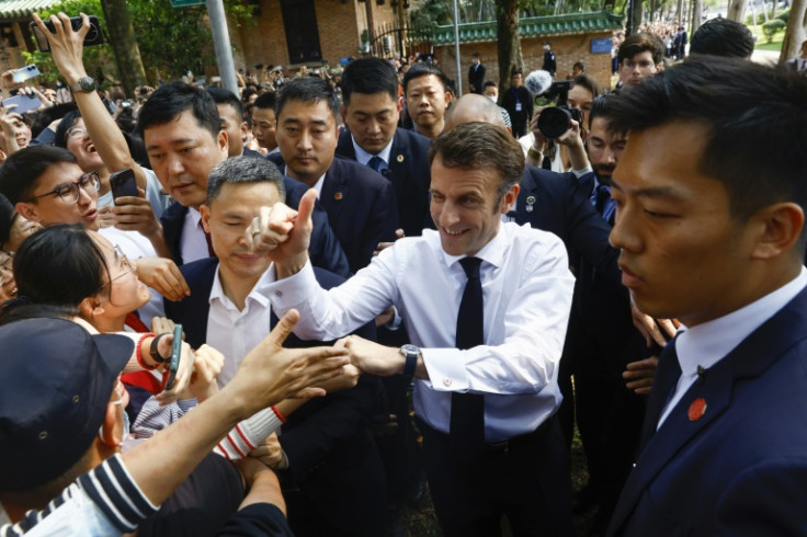 A screaming crowd of students and fans greeted Macron in southern metropolis Guangzhou