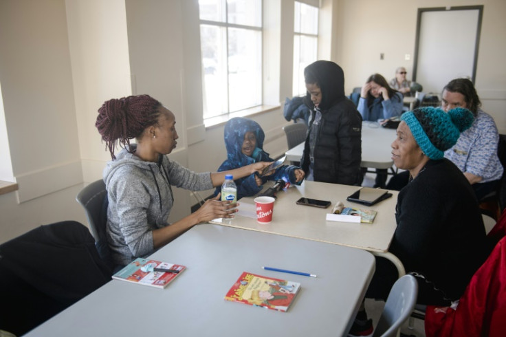 Rosalie Gouba warms up with her mother (right) and two children at a community centre in the Verdun neighbourhood of Montreal, Canada, on April 7, 2023, after freezing rain hit parts of Quebec and Ontario
