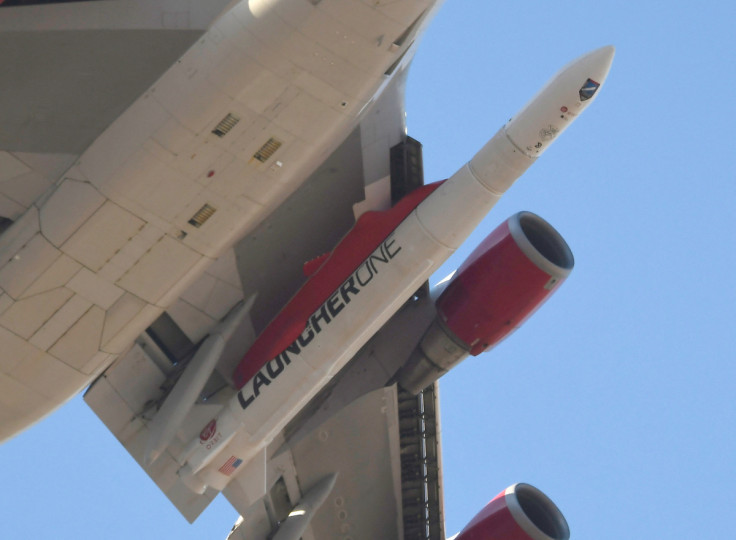 A modified Boeing 747 takes flight carrying Virgin Orbit's LauncherOne rocket, in Mojave