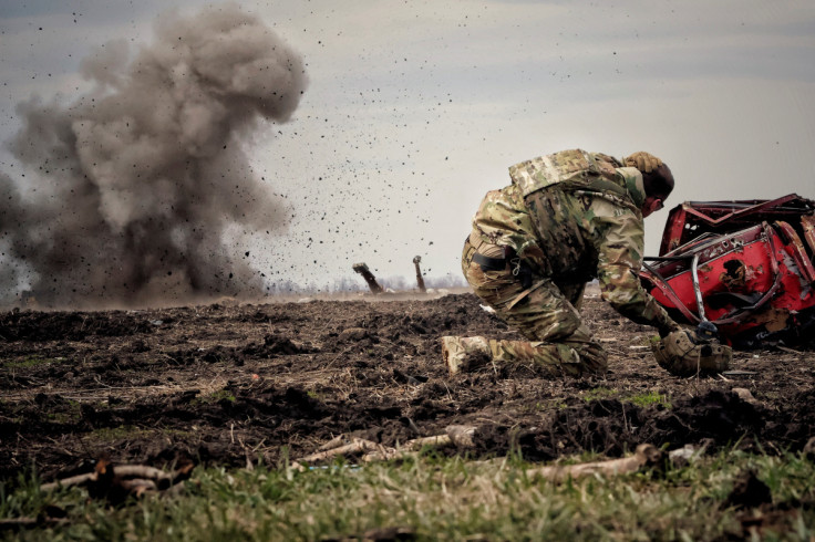 Ukrainian serviceman reacts as he throws a grenade during a training in Donbas region