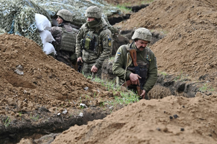 Ukrainian troops in a trench near near the battleground city of Bakhmut on April 8, 2023