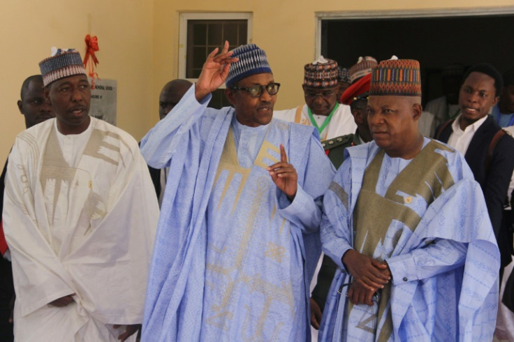 Nigeria President Muhammadu Buhari (middle), with current govenor of Borno State Babagana Zulum (L) and former governor Kashim Shettima (R) who is also vice president-elect.