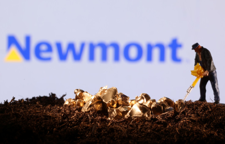 Small toy figure and gold imitation are seen in front of the Newmont logo in this illustration