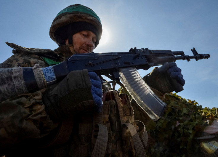 A Ukrainian service member is seen in a trench at a position on a front line near the city of Bakhmut