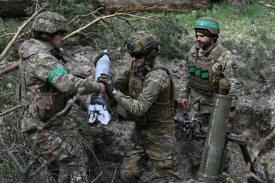 Ukrainian troops prepare to fire a 120 mm mortar toward Russian positions in the Donetsk region on April 5, 2023