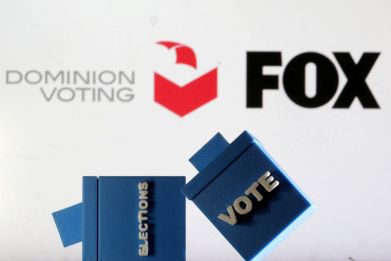 Illustration shows Dominion Voting Systems and Fox logos