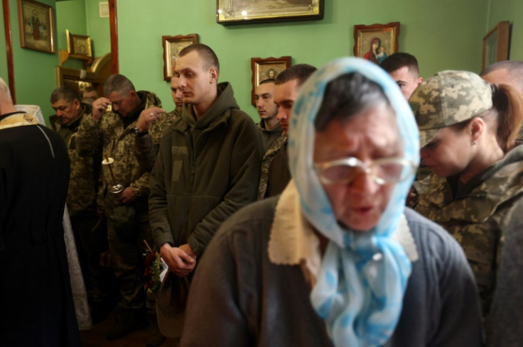 Ukrainian soldiers attend a church service on the eve of the Orthodox Easter in the eastern city of Sloviansk