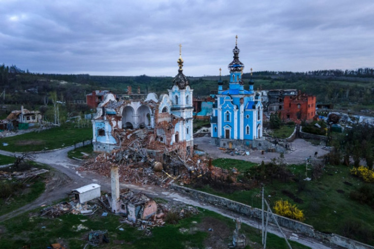 Presiding over the hamlet, on a hill, is what remains of an Orthodox church, one of its onion-domed towers toppled to the ground, a wall gouged by a missile and its pristine walls scabbed by shrapnel