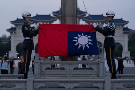 Taiwanese soldiers begin a flag-lowering ceremony in Liberty Square in Taipei