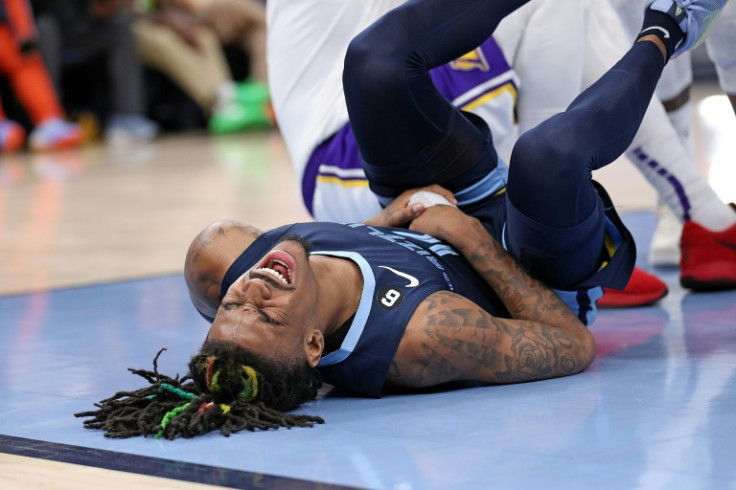 Ja Morant of the Memphis Grizzlies injures his right hand during the fourth quarter of an NBA playoff loss to the Los Angeles Lakers