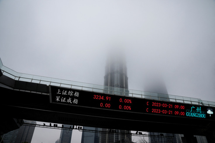 An electronic board shows stock indexes at the Lujiazui financial district in Shanghai