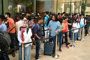 People queue outside India's first Apple store ahead of its Tuesday opening in Mumbai