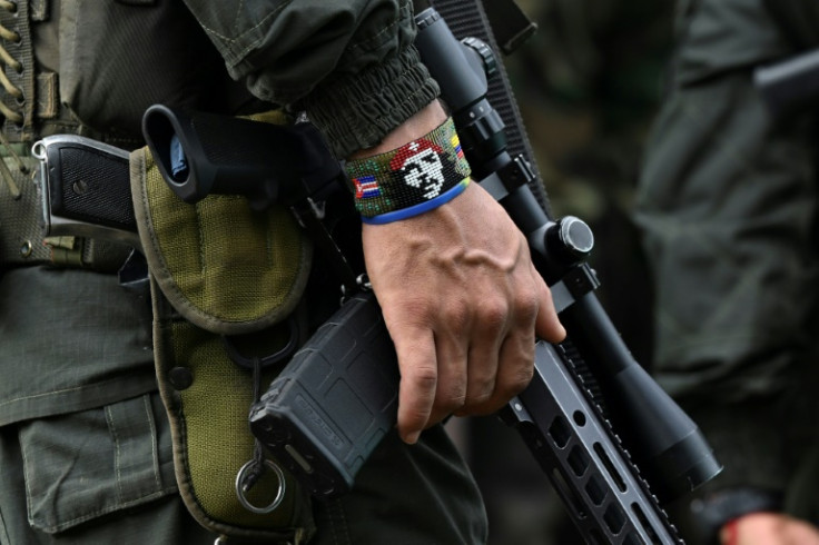 An armed member of a dissident group that broke off from FARC stands guard ahead of a massive rebel meeting in April 2023 in southern Colombia