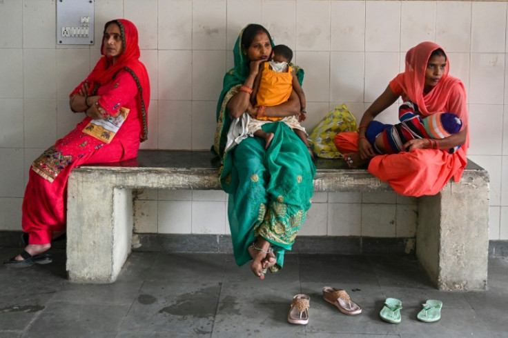Women wait to be sterilised at a health centre in Bhoodbaral in India, which the United Nations estimates will overtake China as the world's most populous country by mid-year