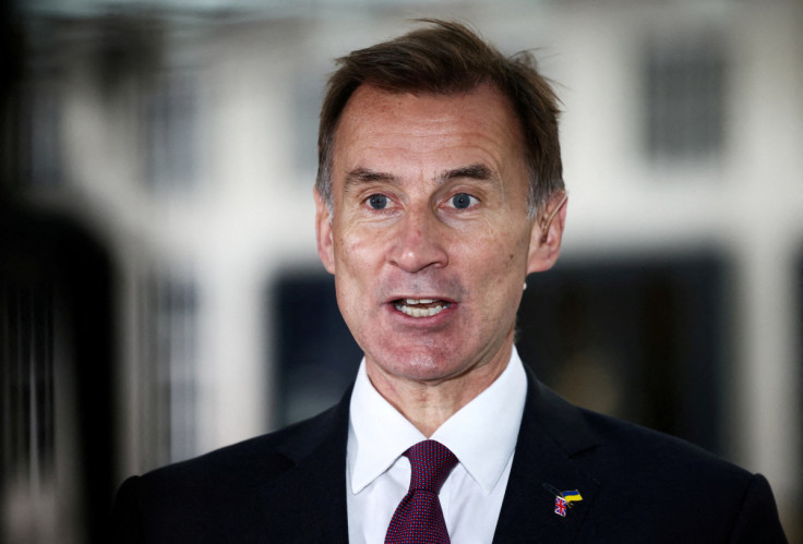 British Chancellor of the Exchequer Jeremy Hunt talks to a television crew outside the BBC headquarters in London