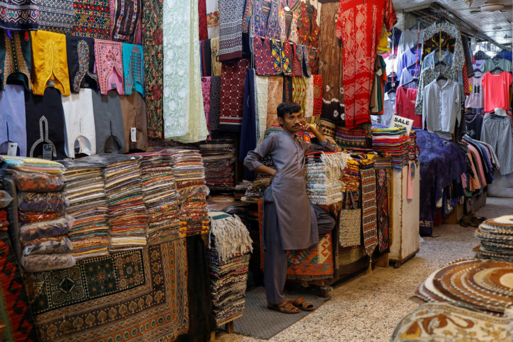 A shopkeeper stands outside his shop while waiting for customers, ahead of Eid al-Fitr celebrations in Karachi