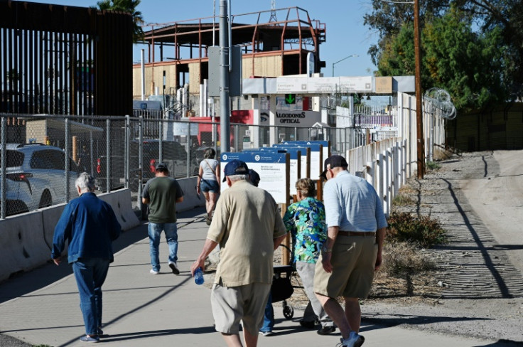 Elderly people walk to the border crossing check point in Andrade, California on their way to the border town of Algodones, Mexico