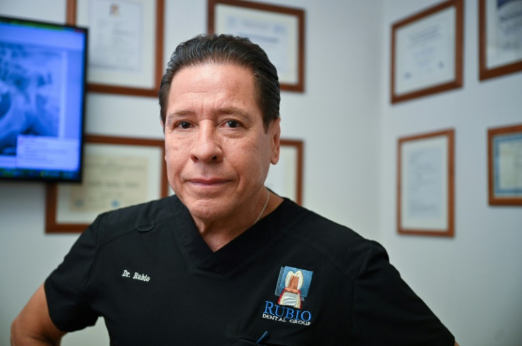 Dentist Carlos Rubio says when he started his practice in 1985, he had to wait four months to see his first patient, but now sees between 30 and 35 people a day