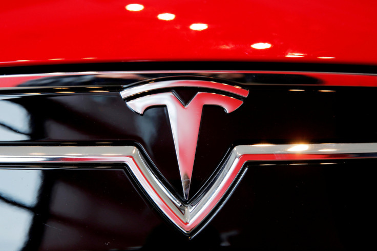 A Tesla logo on a Model S is photographed inside of a Tesla dealership in New York