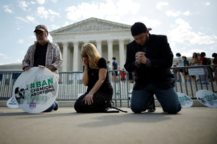 Anti-abortion activists pray outside the US Supreme Court