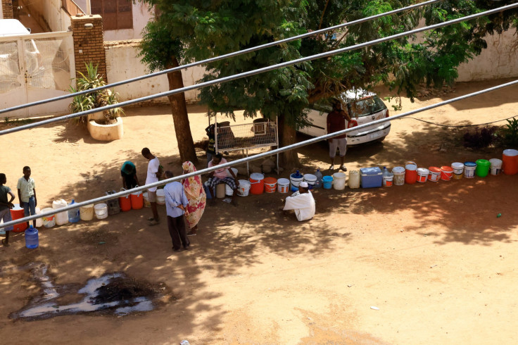 People wait to get water in Khartoum North