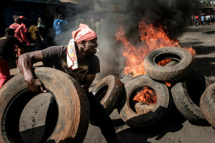 Protesters gather at a burning barricade in Kibera, Nairobi, last month