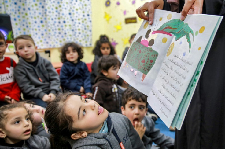 Jordanian teacher Huda Abu al-Khair reads stories to children in a classroom in Amman as part of the "We Love Reading" initiative