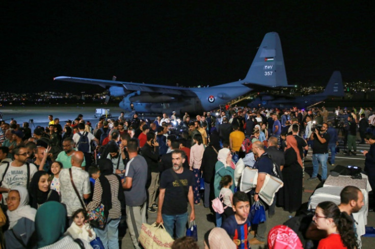 People evacuated from Sudan arrive at a military airport in Amman on April 24, 2023