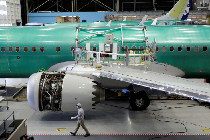 A worker walks past Boeing's new 737 MAX-9 under construction at their production facility in Renton, Washington