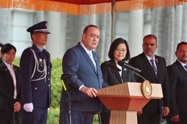 Guatemala President Alejandro Giammattei speaks next to Taiwanese President Tsai Ing-wen during a military welcome ceremony in Taipei