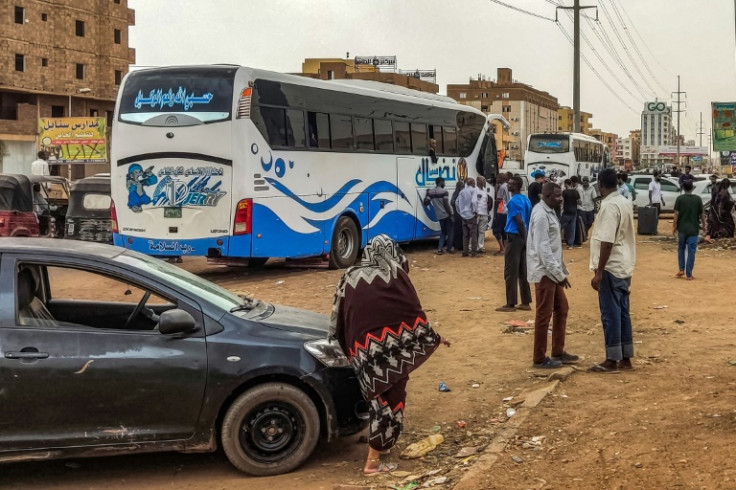 People prepare to board a bus from Khartoum, but fuel is scarce and ticket prices rising