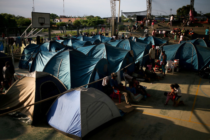 Venezuelan migrants are seen inside a coliseum where a temporary camp has been set up, after fleeing their country due to military operations, according to the Colombian migration agency, in Arauquita