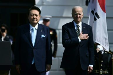 US President Joe Biden and South Korean President Yoon Suk Yeol listen to the national anthems at the White House