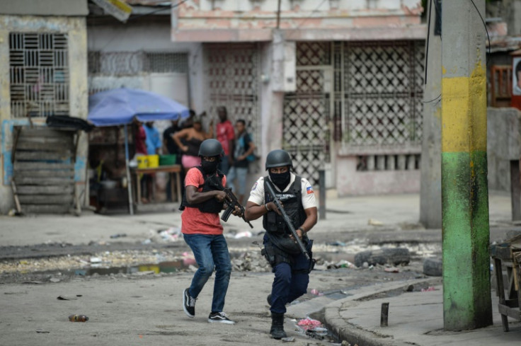 Haitian police officers patrol a neighborhood amid gang-related violence in downtown Port-au-Prince on April 25, 2023