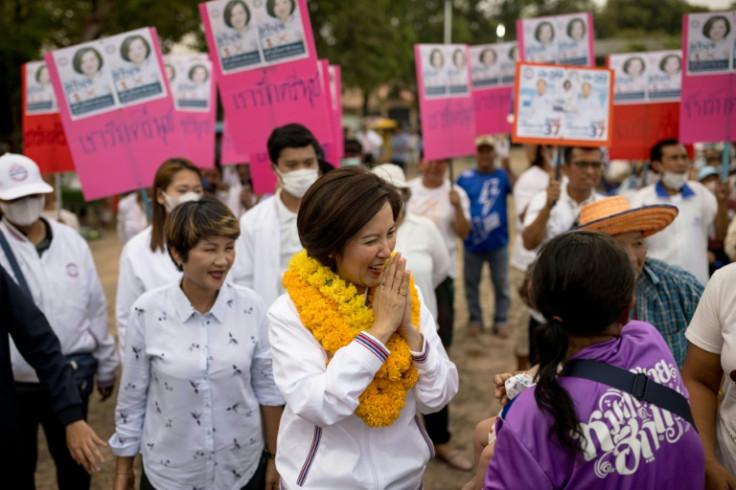 Treenuch Thienthong (C) and her mother are standing for the army-backed Palang Pracharath Party while other members of the clan are running for the main opposition Pheu Thai